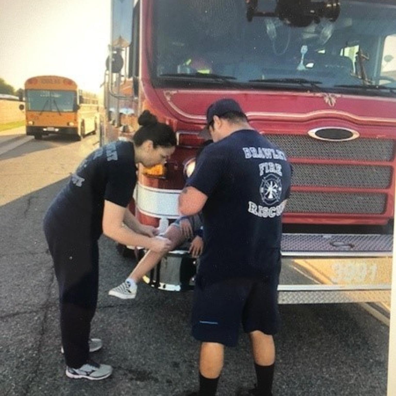 Brawley Firefighters helping an injured child.